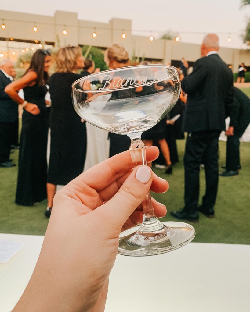 Hand engraved coupe glass with the name Bianca engraved on it at a Scottsdale wedding for custom wedding favors