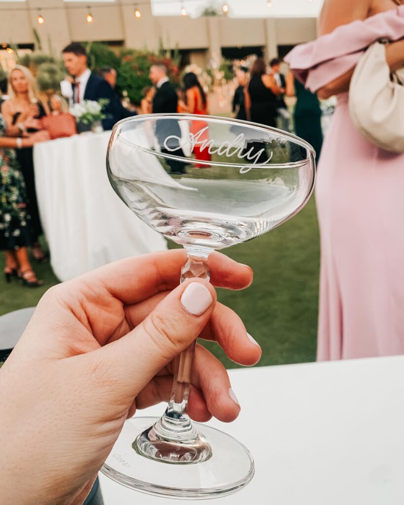 Hand engraved coupe glass with the name Andry engraved on it for a luxury Scottsdale wedding with custom wedding favors